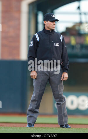 First base umpire Angel Hernandez, right, makes the out call as Texas  Rangers starting pitcher Cliff Lee (33) falls over New York Yankees' Brett  Gardner for an out to end the third