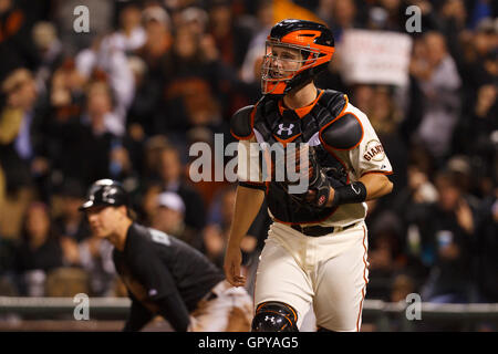 May 25, 2011; San Francisco, CA, USA;  San Francisco Giants catcher Buster Posey (front) returns to the dugout after tagging out Florida Marlins center fielder Chris Coghlan (back) at home plate during the seventh inning at AT&T Park. Stock Photo