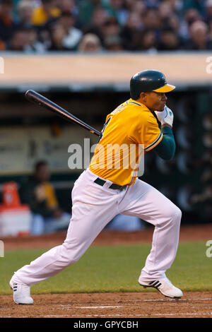 June 18, 2011; Oakland, CA, USA;  Oakland Athletics center fielder Coco Crisp (4) hits a double against the San Francisco Giants during the fourth inning at the O.co Coliseum. Stock Photo