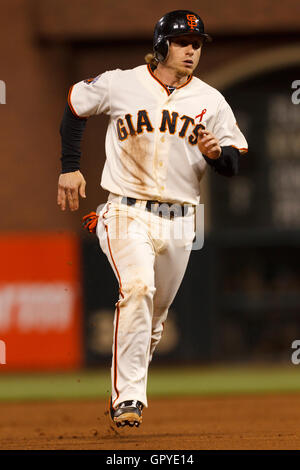 July 18, 2011; San Francisco, CA, USA;  San Francisco Giants shortstop Mike Fontenot (14) runs to third base against the Los Angeles Dodgers during the sixth inning at AT&T Park. Stock Photo