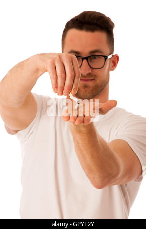 Man breaking cigarette as a gesture of quitting smoking isolated over white. Stock Photo