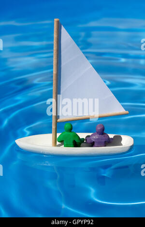 Model yacht with Plasticine people Stock Photo