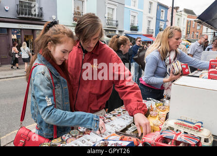 Buying souvenirs at  the Portobello Road Market in London Notting Hill Gate W11 Stock Photo