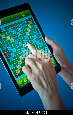 playing Scrabble on tablet iPad Stock Photo
