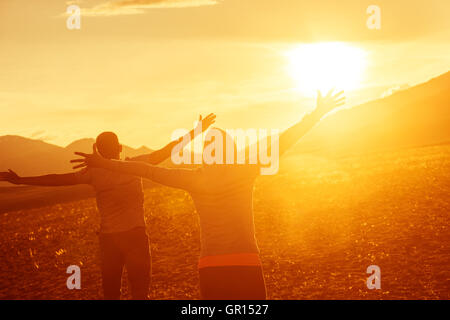 Happy couple having fun on sunset Stock Photo
