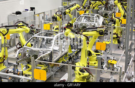 Several welding robots work on the coachwork of the Panamera model the factory in Leipzig, Germany, 02 September 2016. The car manufacturer Porsche is booting up the production of the Panamera model at its Leipzig plant. Since the July summer break, the second generation of the four-door car is now being built completely in Leipzig. Over the past two years the Porsche plant has been extensively expanded, in part for a new plant for bodywork construction. 600 new jobs were created and in autumn more than 4,000 people will be employed in Leipzig. Photo: JAN WOITAS/dpa Stock Photo
