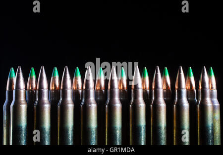 Cartridges with bullets that have steel inside on a dark background Stock Photo