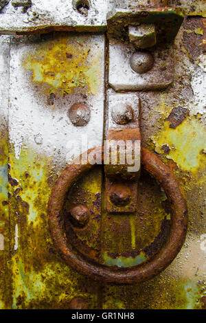 Rusty corroded details on painted steel door Stock Photo