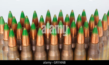 Rifle cartridges with green tipped bullets on a white background Stock Photo