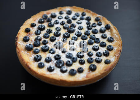 Homemade bluebrry pie on wooden surface. Fresh cooked pastry on a plate. Close up macro, yummy creamy tart Stock Photo
