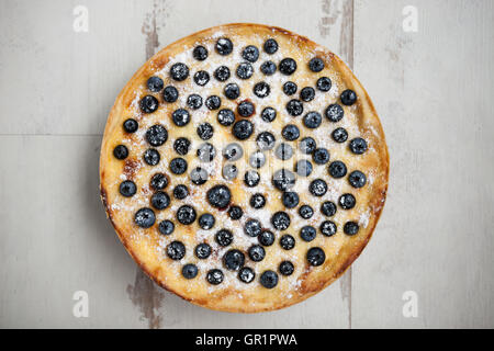 Tasty homemade traditional blueberry pie on white wooden background. Delicious pastry close up, overhead flat lay shot, macro. Stock Photo