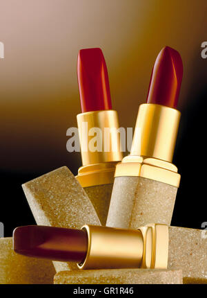Three lipsticks in glamorous arrangement. Stock Photo