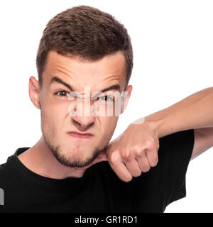 Young man gesturing a cutting motion on her throat over white background. Stock Photo