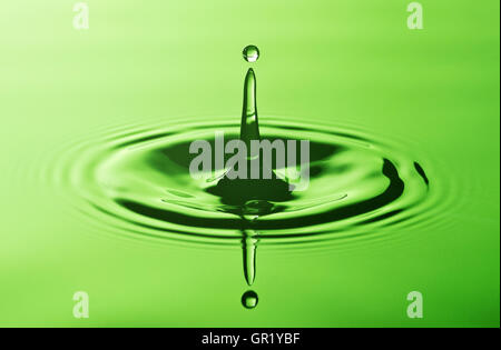 Close-up of a drop hitting surface of water Stock Photo