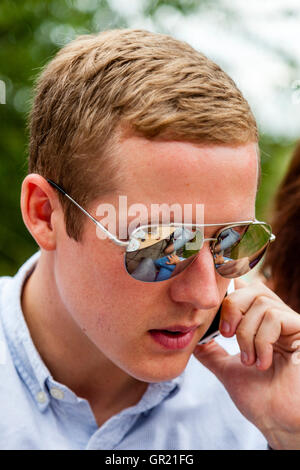 A Good Looking Young Man Using A Mobile Phone, Sussex, UK Stock Photo