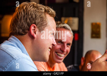 Family Conversations Around The Dinner Table In A Village Pub, Sussex, UK Stock Photo