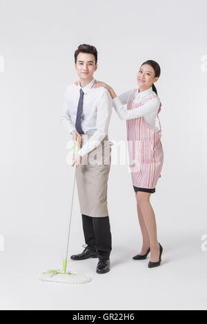Young harmonious couple doing chores Stock Photo