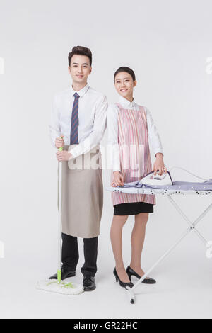 Harmonious young couple doing chores Stock Photo