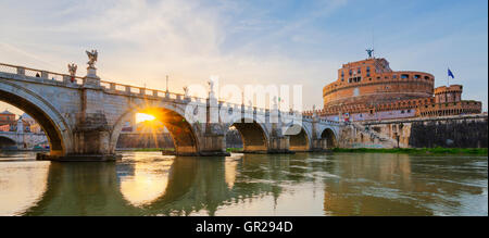 Castle of Holy Angel and Holy Angel Bridge over the Tiber River in Rome at sunset. Stock Photo