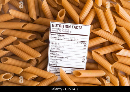 Nutrition facts of Brown Rice Pasta on pasta background. Close-up. Stock Photo