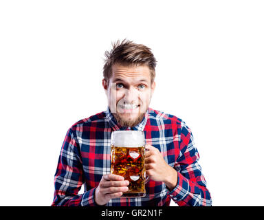 Hipster man in checked shirt drinking beer, studio shot Stock Photo