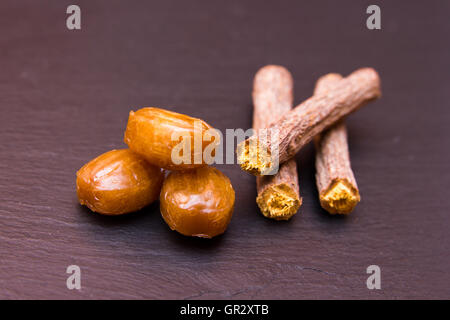 Some licorice candies on a slate floor Stock Photo