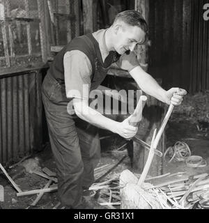 1950s, historical, male craftsman in workshop using a drawknife to hand-shave or strip cricket bat willow. Stock Photo