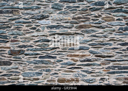 Brown and Slate Stone Wall with tan cement grout Stock Photo