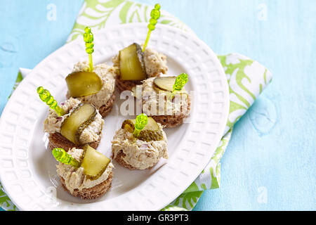 Canapes with fish pate and pickle. Party food Stock Photo