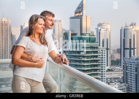 middle aged couple enjoying the view from a balcony Stock Photo