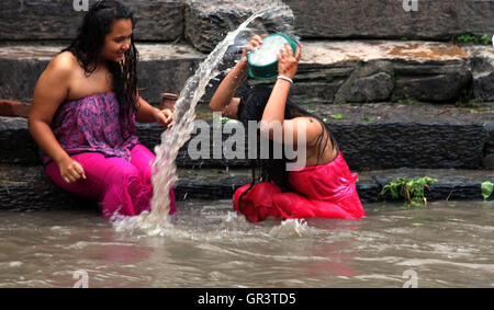 Kathmandu, Nepal. 06th Sep, 2016. Hindu women take a bath ritual by using Dattiwan (sacred twigs) during Rishi Panchami festival on the bank of Bagmati river. Rishi Panchami, also known as Bhadraprada Sukla Panchami, is the last day of Teej Festival.On the occasion, women take a bath early in the morning to mark Rishi Panchami and seek forgiveness for ‘sins' committed during monthly periods.Hindu women offer prayers to Saptarshis (seven saints). © Archana Shrestha/Pacific Press/Alamy Live News Stock Photo