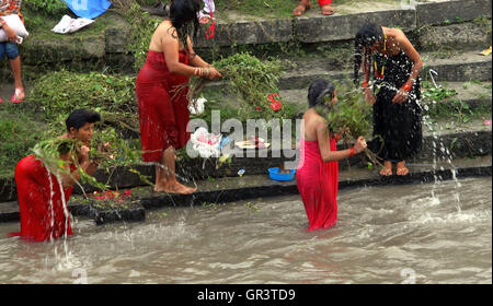 Kathmandu, Nepal. 06th Sep, 2016. Hindu women take a bath ritual by using Dattiwan (sacred twigs) during Rishi Panchami festival on the bank of Bagmati river. Rishi Panchami, also known as Bhadraprada Sukla Panchami, is the last day of Teej Festival.On the occasion, women take a bath early in the morning to mark Rishi Panchami and seek forgiveness for ‘sins' committed during monthly periods.Hindu women offer prayers to Saptarshis (seven saints). © Archana Shrestha/Pacific Press/Alamy Live News Stock Photo