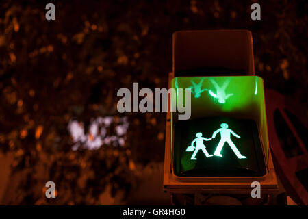 Pedestrian and  crossing sign light on for schoolchildren at night Stock Photo