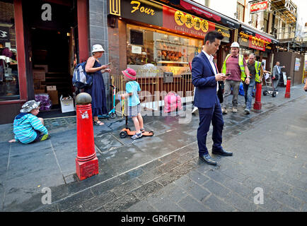 London, England, UK. Man on his mobile phone in Chinatown Stock Photo