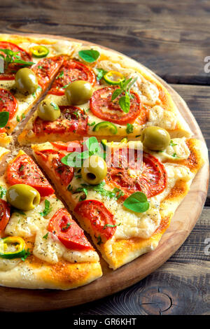 Italian pizza with cherry tomatoes and green basil on white Stock Photo ...