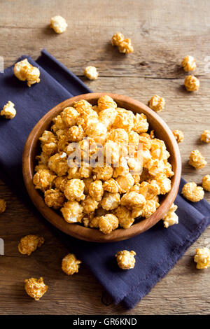 Homemade caramel popcorn in wooden bowl Stock Photo