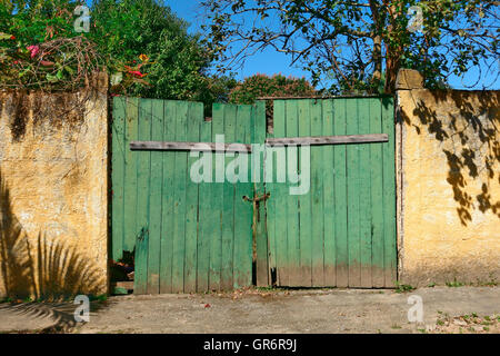 Locked green gate at the entrance to a property in Brazil Stock Photo