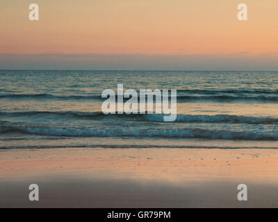 Tranquil Beach Scene Retro Styled, Sunset, Sunrise Stock Photo