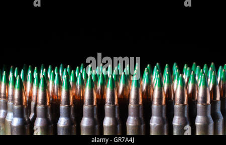 Bullets with green tips on rifle cartridges and a black background Stock Photo