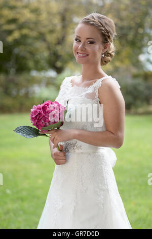 Three-Quarter Shot Of A Pretty Young Bride In White Wedding Dress Stock Photo