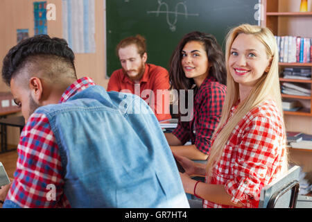 Mixed Race Students Group With Professor Sit Desk University Classroom, Two Beautiful Young Girls Wear Checked Shirt Stock Photo