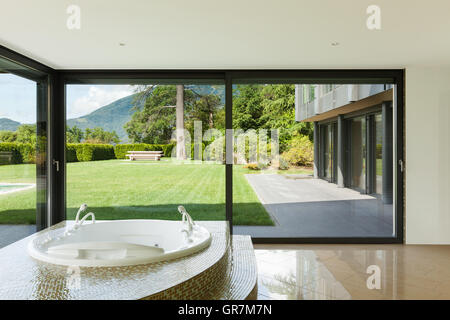 beautiful room with jacuzzi, window overlooking the garden Stock Photo