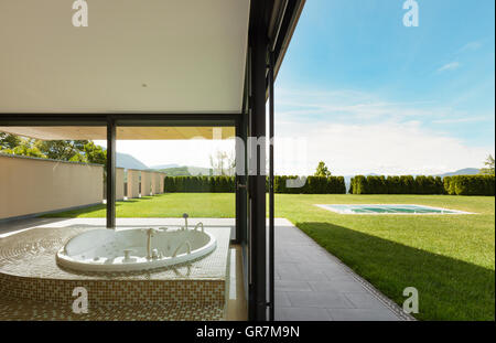 beautiful room with jacuzzi, window overlooking the garden Stock Photo