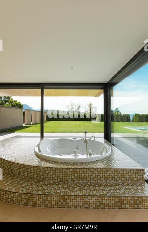 beautiful room with jacuzzi, window overlooking the garden Stock Photo