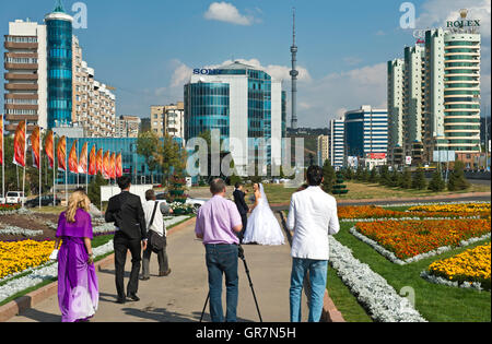 Newly Married Couple On A Walk In A Public Green Space, Almaty, Kazakhstan Stock Photo