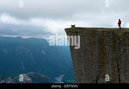 Visitor On The Preikestolen, Pulpit Rock, At Lysefjord, Rogaland Province, Norway Stock Photo