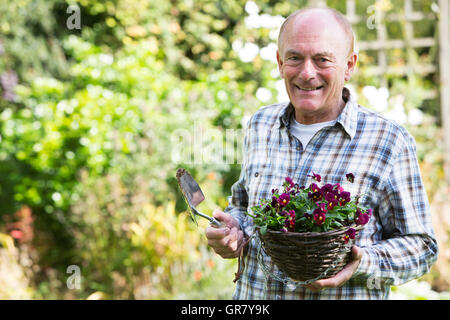 Portrait Of Senior Man Working In Garden Stock Photo
