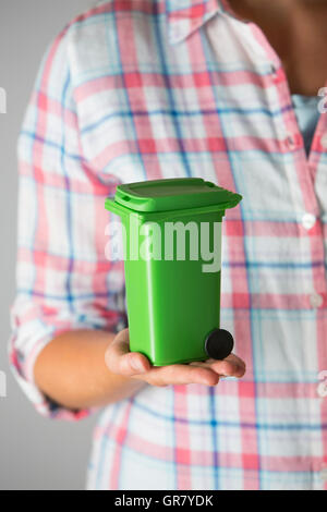 Close Up Of Woman Holding Model Recycling Bin Stock Photo