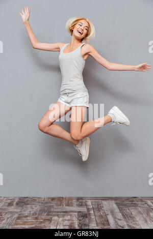 Cheerful Smiling Hipster Style Girl Jumping And Posing In Autumn Clothes  Stock Photo - Download Image Now - iStock