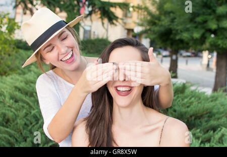 Who is there. Two girls having fun in the park Stock Photo